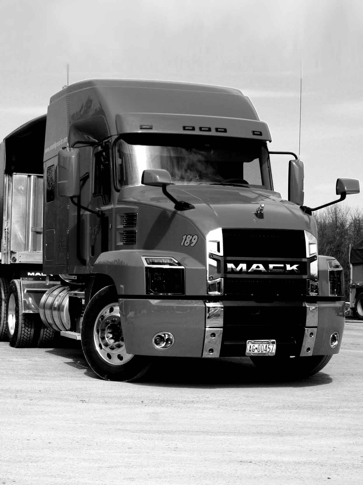 A black and white photo of a single Ronald Gross Inc. flatbed truck.