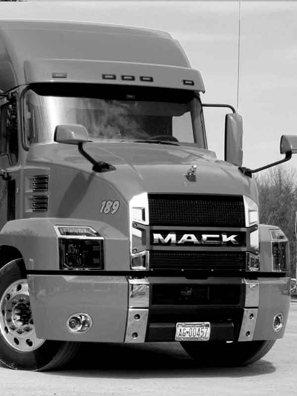 A black and white photo of a single Ronald Gross Inc. flatbed truck.